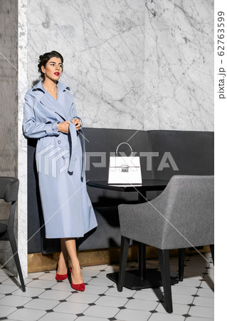 Model dressed in fashionable clothes posing indoors 62763599