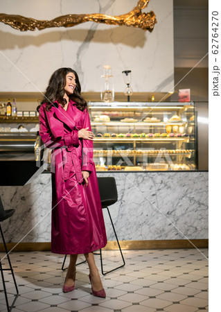 Model dressed in fashionable clothes posing in restaurant 62764270