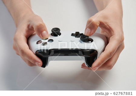 Grey game controller in hand Grey game controller in hand 62767881