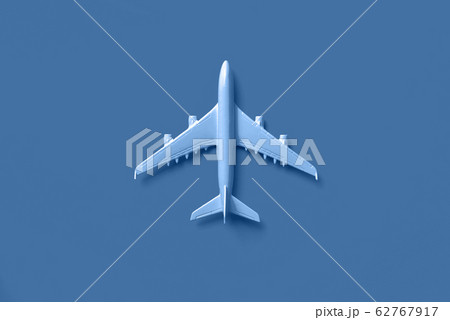 White plane, airplane in trendy blue and calm color. Rainbow gradient background with copy space. Top view, flat lay. Minimal style design. Travel, vacation concept. 62767917