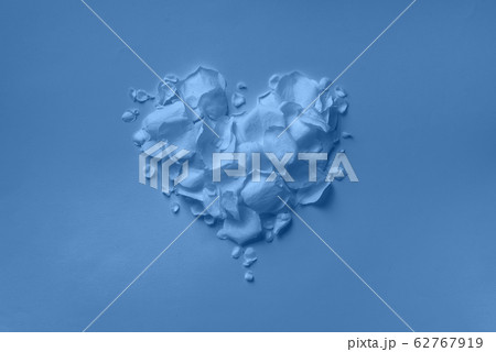 Heart shape made of rose petals on monochrome background. Top view, flat lay. Summer concept in trendy blue and calm color. Valentine's day. Creative layout. Heart shape made of rose petals on monochrome background. Top view, flat lay. Summer concept in trendy blue and calm color. Valentine's day. Creative layout. 62767919
