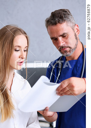 Concerned handsome doctor communicate with patient 62768879