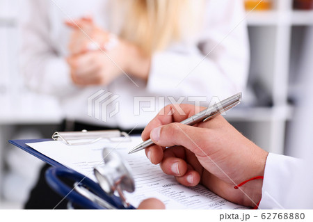 Male doctor arm hold silver pen Male doctor arm hold silver pen 62768880