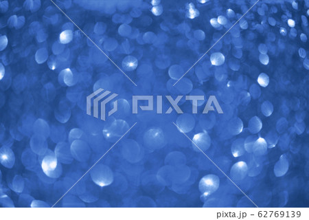 Holiday abstract texture. Christmas card with copy space. Сlassic blue background bokeh, defocused lights. 62769139