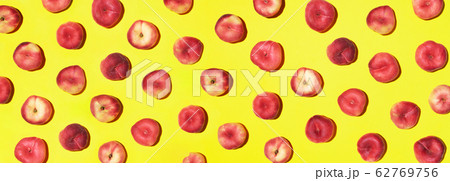 Peaches pattern on pastel yellow background. Frame made of fresh fruits. Flat lay, top view, copy space. Vegan and vegetarian diet. Banner 62769756