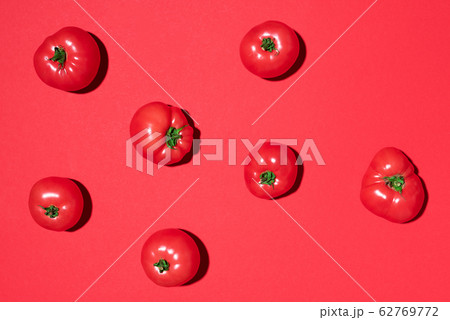 Red tomatoes pattern on red background. Flat lay, top view. Summer minimal concept. Vegan and vegetarian diet Red tomatoes pattern on red background. Flat lay, top view. Summer minimal concept. Vegan and vegetarian diet 62769772