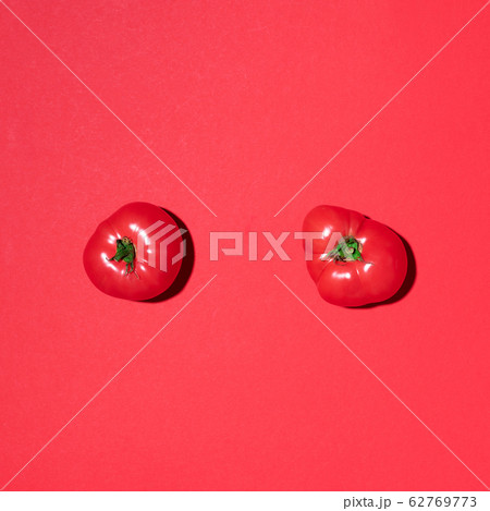 Red tomatoes pattern on red background. Flat lay, top view. Summer minimal concept. Vegan and vegetarian diet Red tomatoes pattern on red background. Flat lay, top view. Summer minimal concept. Vegan and vegetarian diet 62769773