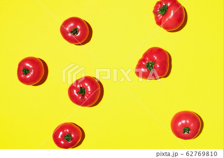 Red tomatoes pattern on yellow background. Flat lay, top view. Summer minimal concept. Vegan and vegetarian diet Red tomatoes pattern on yellow background. Flat lay, top view. Summer minimal concept. Vegan and vegetarian diet 62769810