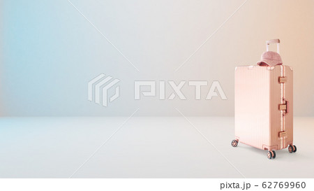 Pink hand carry luggage with pink cap on milky white background with slightly blue and orange lighting . Pink hand carry luggage with pink cap on milky white background with slightly blue and orange lighting . 62769960