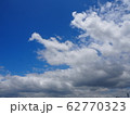 Blue sky and white cloud. The moon is on the sky and a plane is flying on the sky too. 62770323