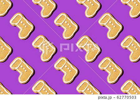 Christmas gingerbread pattern on violet background. Top view. Flat lay. Boot shapes cookies. New year and Christmas concept 62770503