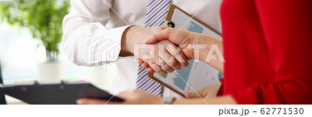 Business people standing in office and making agreement Business people standing in office and making agreement 62771530