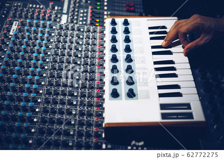 musician hands playing midi keyboard in recording studio. music production concept 62772275