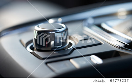 Closeup of a modern car interior with media and navigation control buttons Closeup of a modern car interior with media and navigation control buttons 62773237