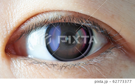 Closeup of camera len inside the women eye , futuristic digital vision technology concept . 62773377