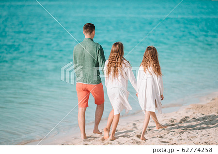 Father and little kids on the beach 62774258