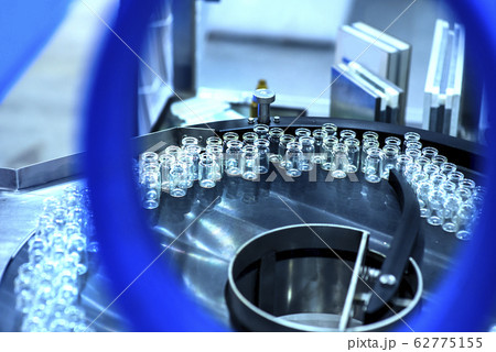 pharmaceutical industry. Production line machine conveyor at factory with bottles 62775155