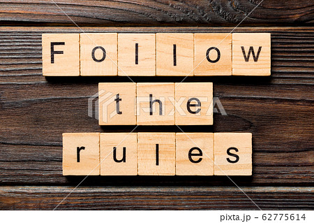 Follow The Rules word written on wood block. 62775614