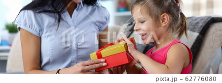 Mom giving gift to girl 62776080