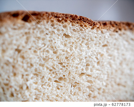 Porous white roll in a section. Close-up. 62778173