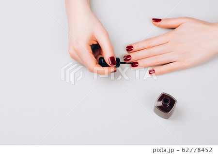Woman making self manicure 62778452