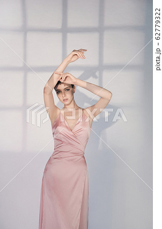 Beautiful woman pose in studio in pink classic Beautiful woman pose in studio in pink classic 62779322