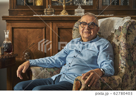 Senior Jew sitting in armchair in traditional home  62780403