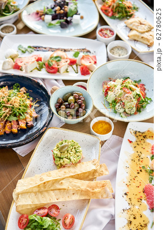 Many different delicious dishes dishes on the table. Various snacks and antipasti on the table. Restaurant menu. Italian cuisine 62780625