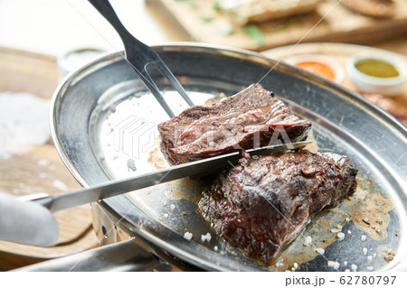 Various grilled meat set with Pickled cabbage and two sauces. Serving on a wooden Board. Barbecue restaurant menu, a series of photos of different meats. Various grilled meat set with Pickled cabbage and two sauces. Serving on a wooden Board. Barbecue restaurant menu, a series of photos of different meats. 62780797
