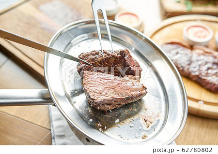 Various grilled meat set with Pickled cabbage and two sauces. Serving on a wooden Board. Barbecue restaurant menu, a series of photos of different meats. 62780802