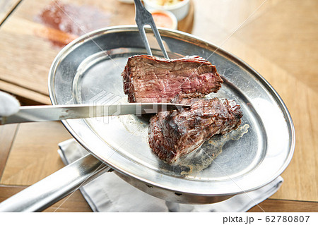 Various grilled meat set with Pickled cabbage and two sauces. Serving on a wooden Board. Barbecue restaurant menu, a series of photos of different meats. 62780807