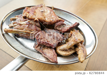 Various grilled meat set heated on coals. Barbecue restaurant menu. Many different food on the table. Dinner party or Banquet Various grilled meat set heated on coals. Barbecue restaurant menu. Many different food on the table. Dinner party or Banquet 62780844