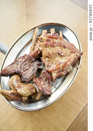 Various grilled meat set heated on coals. Barbecue restaurant menu. Many different food on the table. Dinner party or Banquet 62780845
