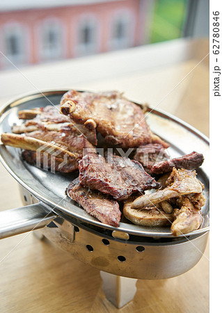 Various grilled meat set heated on coals. Barbecue restaurant menu. Many different food on the table. Dinner party or Banquet 62780846