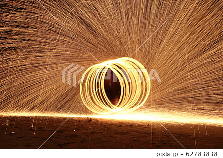 Skill Man playing fireworks by spinning wood pole 62783838