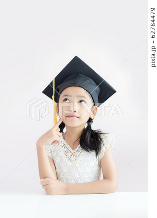Portrait little Asian girl is wearing graduate hat Portrait little Asian girl is wearing graduate hat 62784479