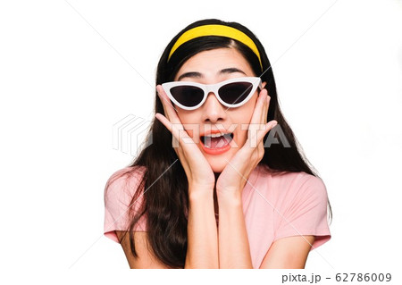Young beautiful asian woman,long black hair Wearing a pink t-shirt, White fashion glasses, Yellow hair band smiling and Surprised isolated on white background 62786009