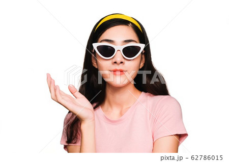 Young beautiful asian woman,long black hair Wearing a pink t-shirt, White fashion glasses, Yellow hair band smiling and Surprised isolated on white background 62786015