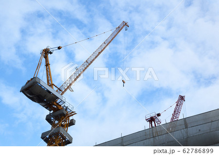 Construction tower cranes building on  empty blue sky background 62786899