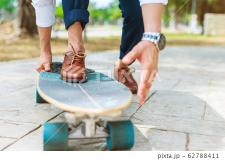 Businessman person leather boot riding skate board 62788411