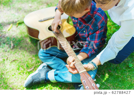 Happy boy in checkered shirt playing and learning 62788427