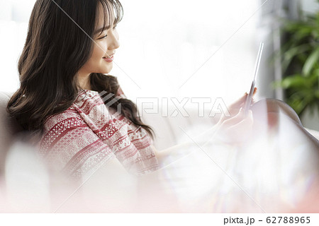A young lady with a smartphone on the sofa A young lady with a smartphone on the sofa 62788965