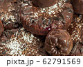 Background of homemade chocolate sweets. Natural chocolate candies. Coconut raisin cookies. Top view. Selective focus. Healthy and delicious meal. Harmless treat to tea for vegan and vegetarian diet 62791569