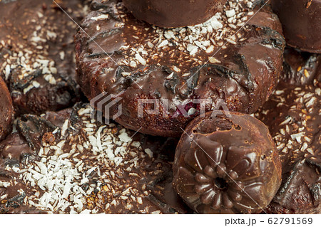 Background of homemade chocolate sweets. Natural chocolate candies. Coconut raisin cookies. Top view. Selective focus. Healthy and delicious meal. Harmless treat to tea for vegan and vegetarian diet 62791569