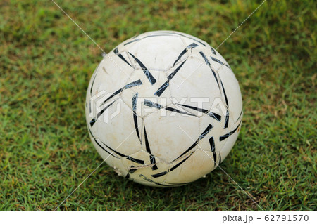 Old ball on grass 62791570