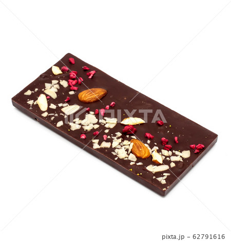 Handmade dark chocolate bar with a variety of dried fruit and nut toppings 62791616