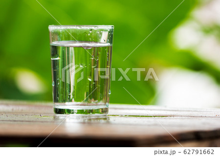 Glass of water on a wooden board 62791662