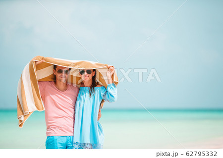 Young happy family during tropical beach vacation Young happy family during tropical beach vacation 62795332