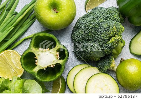 Fresh green vegetables and herbs on a grey Fresh green vegetables and herbs on a grey 62796137
