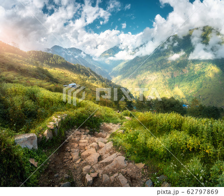 Beautiful stone trail in mountain valley at sunset in spring in Nepal. Landscape with stone steps Beautiful stone trail in mountain valley at sunset in spring in Nepal. Landscape with stone steps 62797869